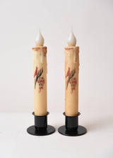 The "I am Always with You Cardinal" LED Timer Taper Candles feature faux wax drips, black bases, cinnamon dusting, a red cardinal design, and heartfelt text—perfect battery-operated accents for farmhouse décor.
