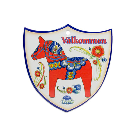 Add Swedish charm to your home with the Tile: Red Dala Horse Valkommen Ceramic Decoration Shield, featuring a red Dala horse, floral accents, and Välkommen at the top—a warm and inviting decor piece.