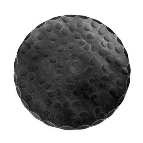 The Candle Holder: Forged Steel Pillar Candle Base (4.75" diameter) features a round, black matte finish with a raised dot pattern, adding artisanal flair to any setting.