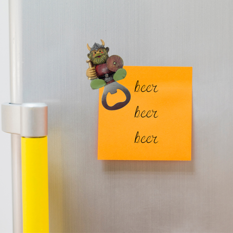 The Magnet: Norwegian Viking Refrigerator Magnet Bottle Opener is attached to a fridge, holding an orange sticky note with “beer beer beer” in cursive—a playful and functional addition to your kitchen decor.