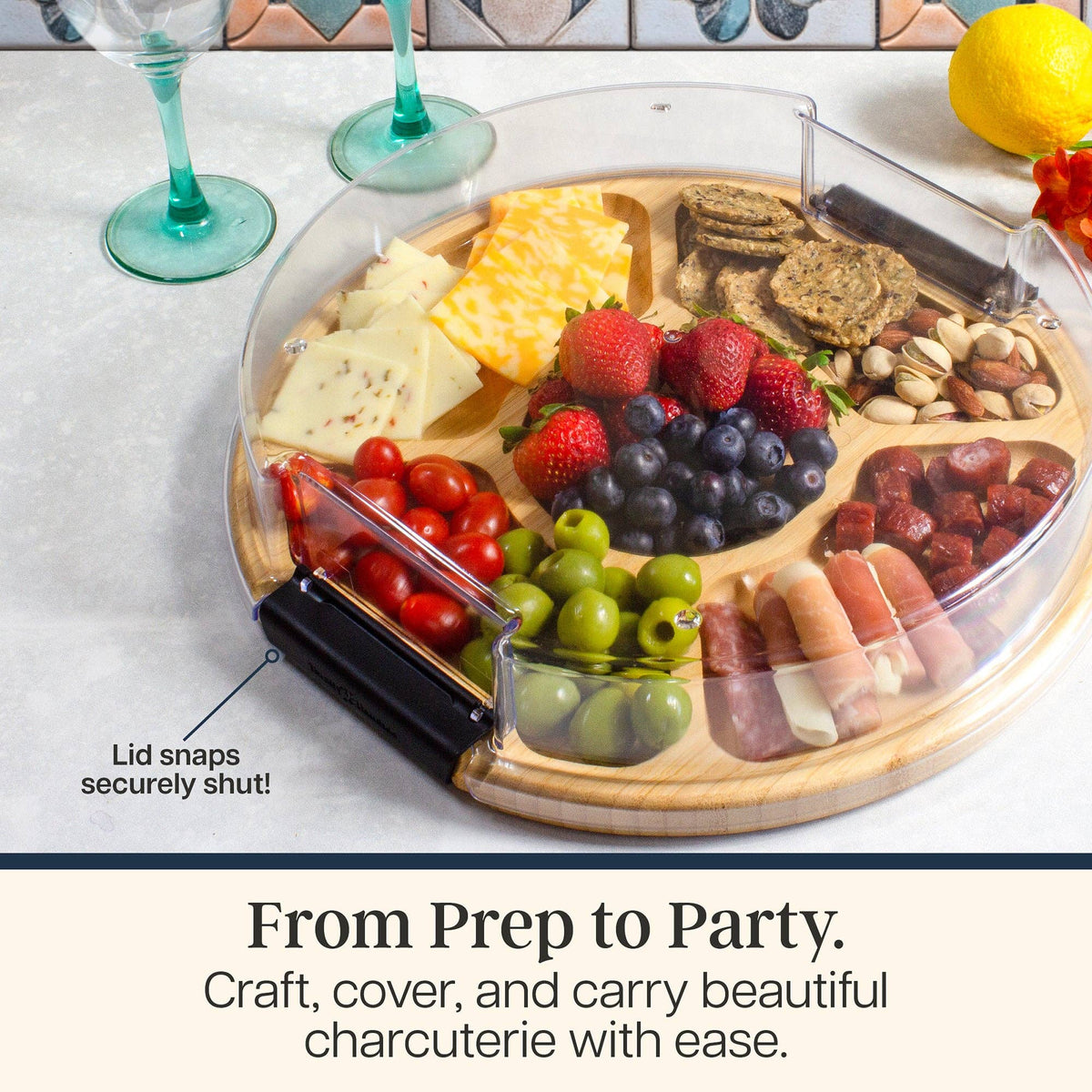 Bamboo charcuterie board with sections filled with cheese, fruit, nuts, and meats, featuring a clear plastic lid with a black locking handle.