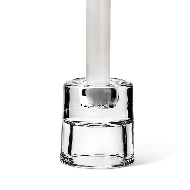 A versatile 2.5" glass holder stands upright on a white background, showcasing its reversible design as both a taper and tealight candle holder, making it an elegant yet practical addition to any setting.