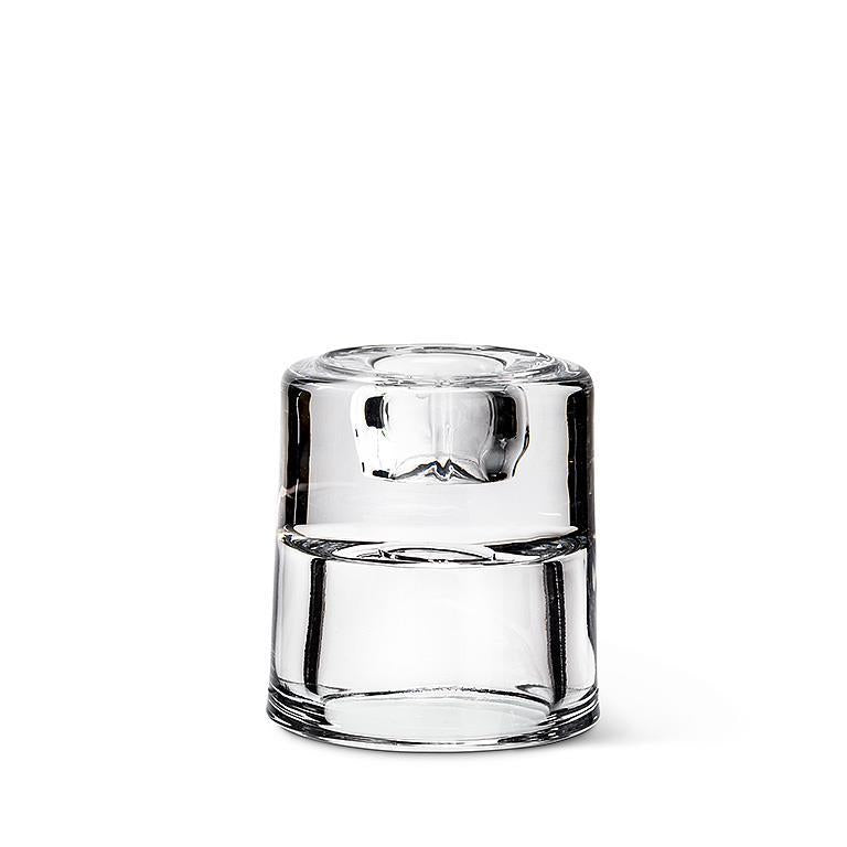 This clear 2.5" glass piece, set against a white background, functions as the versatile Candle Holder: a Reversible Taper/Tealight Holder.