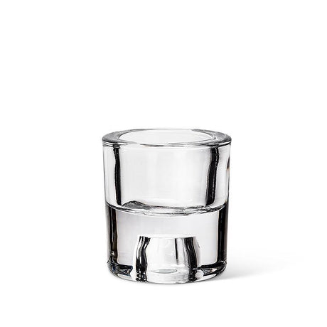 A 2.5" glass reversible taper/tealight holder, which resembles a clear shot glass, is elegantly displayed on a white background.