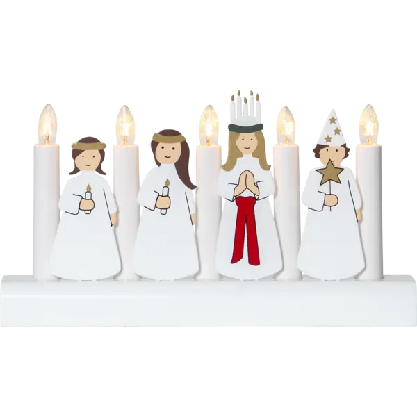The Star Trading - Candlestick Julia, a 5-light electric candelabra, illuminates a cozy Christmas scene with wooden figures dressed in white robes holding candles as they stand on a white base.