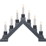 The Candelabra: Star Trading - Karin Electric 7-Light features black triangular design with nine glowing white candles, reminiscent of a traditional Swedish Christmas candlestick, arranged in an elegant ascending order on each side.