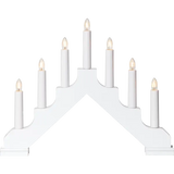 The Star Trading Ada is a white, electric 7-light candelabra with candles arranged in a stepped, triangular pattern.