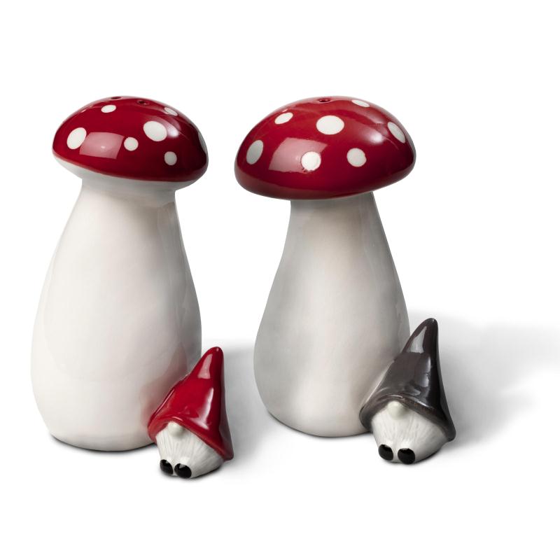 The Salt & Pepper: Mushrooms & Gnomes set, crafted by Swedish designers, features ceramic shakers styled as tall mushrooms with red caps. Accompanying them are two delightful gnomes—one wearing a red hat and the other in gray—bringing a playful touch to your table decor.