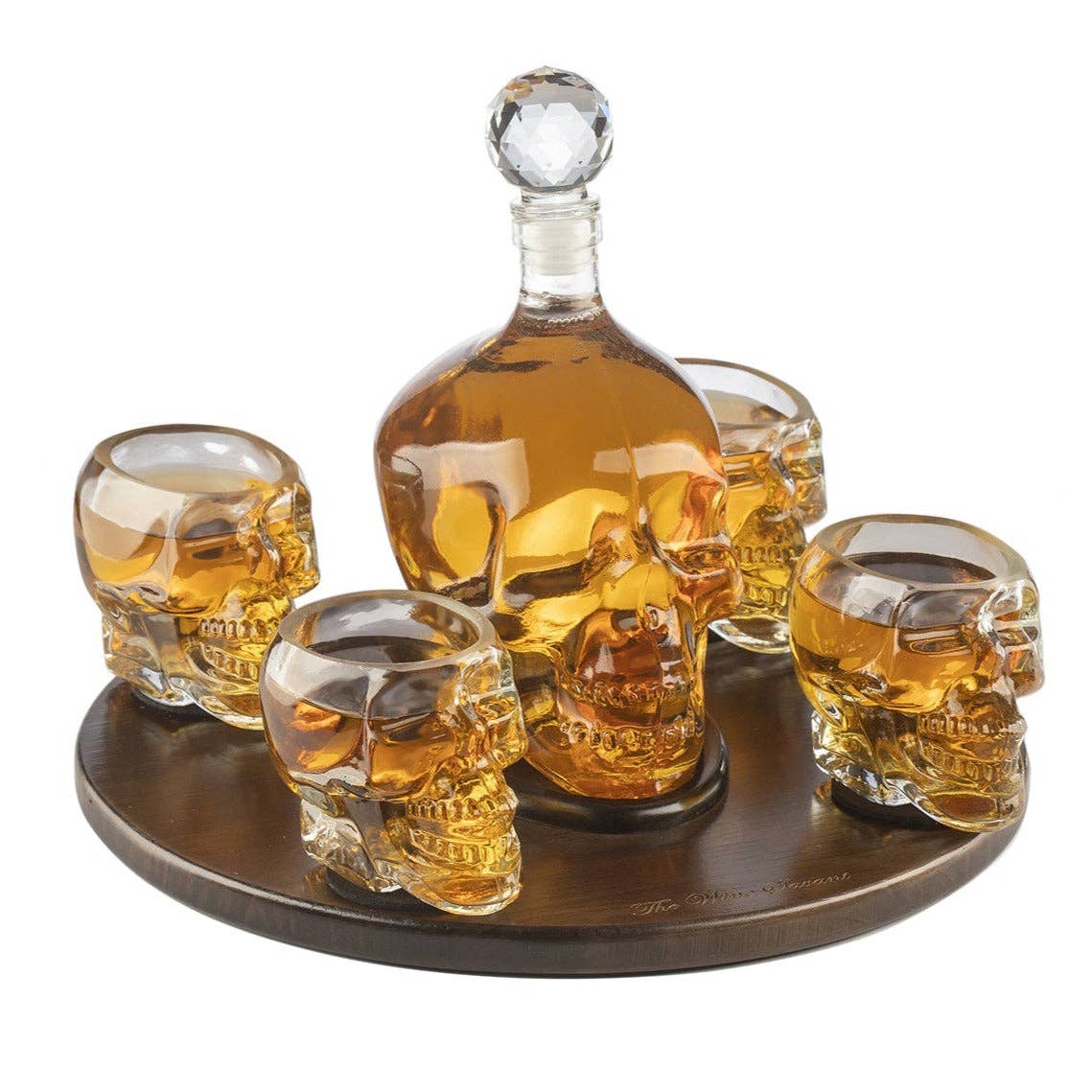 The Skull Decanter Set with 4 Skeleton Skull Shot Glasses is displayed on a round wooden tray—an eye-catching piece to give your pirate-themed party a bold, adventurous flair.