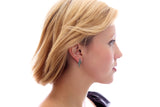 A woman with short blonde hair and a black top is shown in profile against a white background, wearing May Emerald Beautiful Spiral Swarovski® Crystals Silver Earrings.