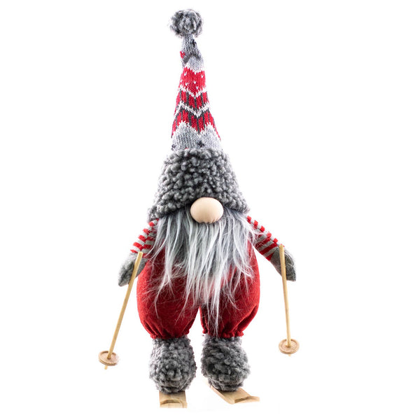 Nene the Gnome – Standing Gnome on Skis (16" tall) features a long gray beard, red and gray hat, and wooden ski poles—perfect as a charming Scandinavian holiday accent for your Nordic winter decor.