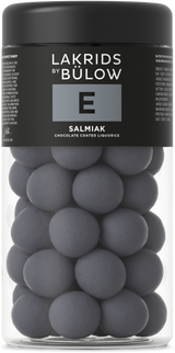 A clear jar with a black lid and gray front label contains round, dark gray chocolate-coated licorice candies. The Nordic brand name is visible on the label.