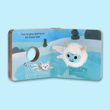 An open finger puppet book featuring a white plush yeti and white tiger on a blue frozen lake, with the text: Then he goes skating on the frozen lake.