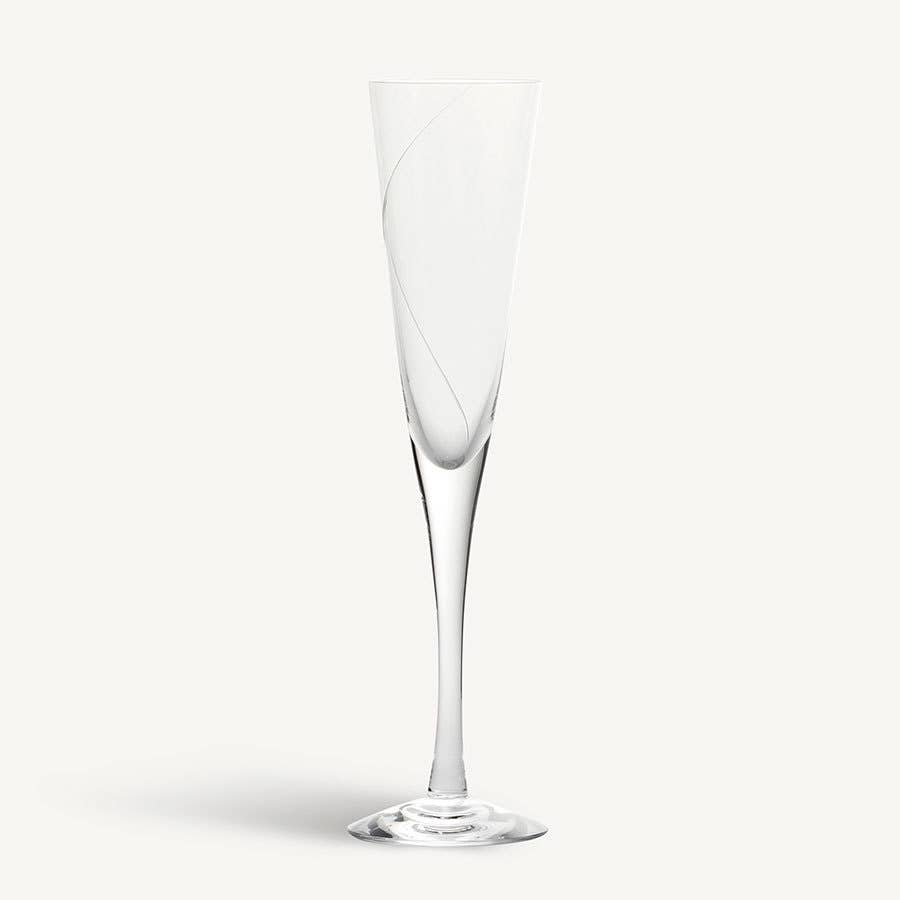 The KostaBoda Line Flute Champagne Glass is a mouth-blown clear glass featuring a slender stem and subtle curved line design, elegantly displayed against a plain white background.