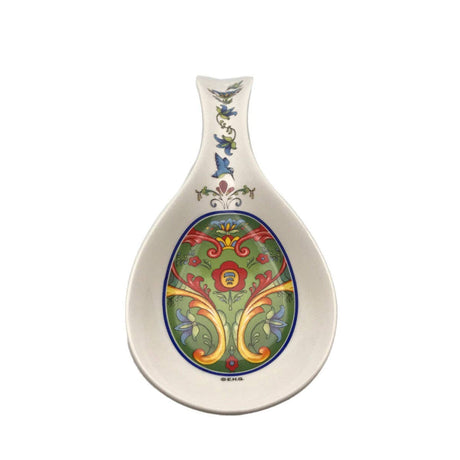 Add Scandinavian charm to your kitchen with the Green Norwegian Rosemaling Ceramic Spoon Rest, featuring colorful floral and scroll patterns in green, red, yellow, and blue on a white background.