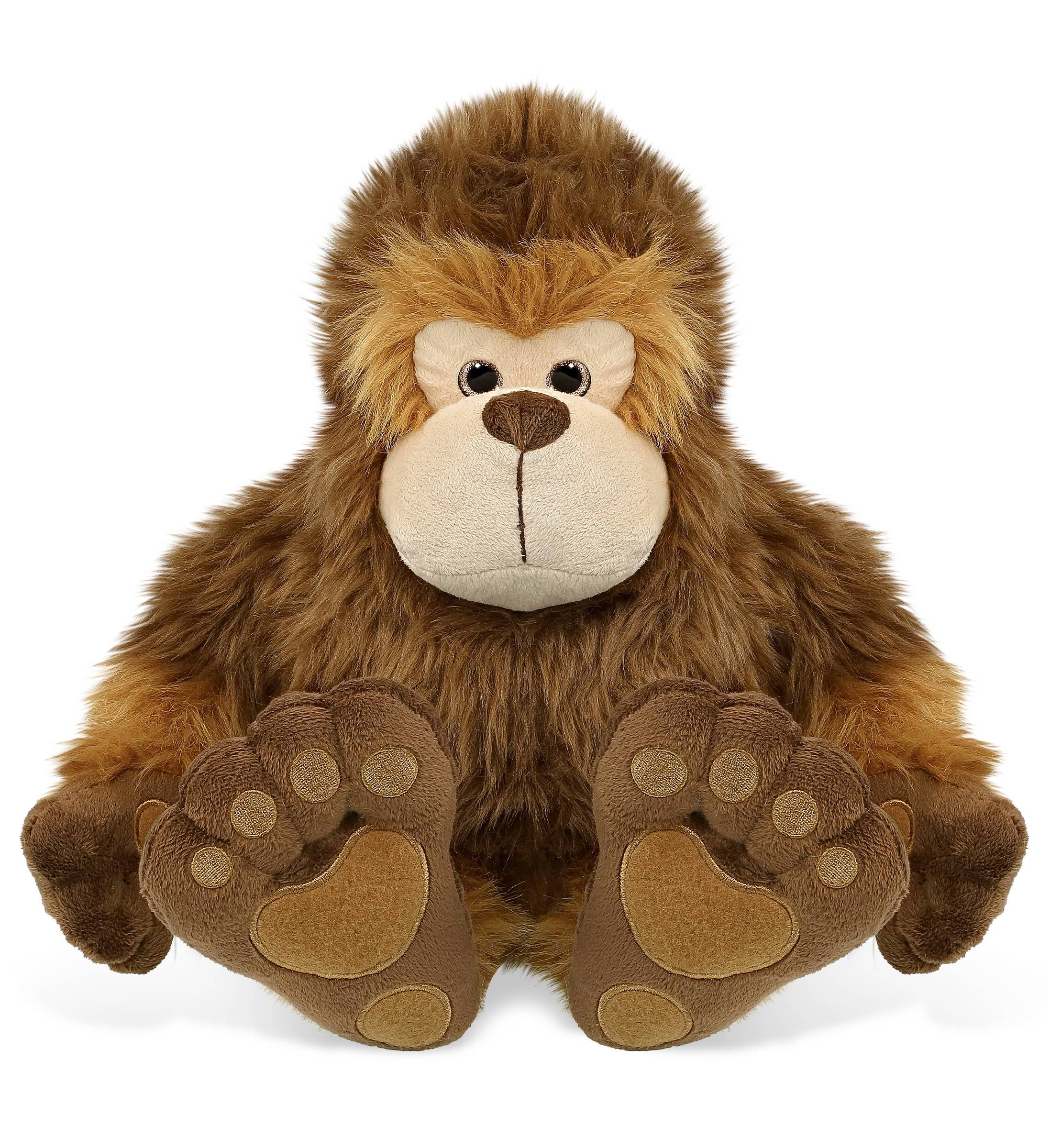 The Plush: Super-Soft Big Foot Stuffed Plush features brown fur, a beige face, and large embroidered feet, sitting upright and facing forward to resemble a charming stuffed Bigfoot cryptid plush toy.