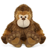 The Plush: Super-Soft Big Foot Stuffed Plush features brown fur, a beige face, and large embroidered feet, sitting upright and facing forward to resemble a charming stuffed Bigfoot cryptid plush toy.