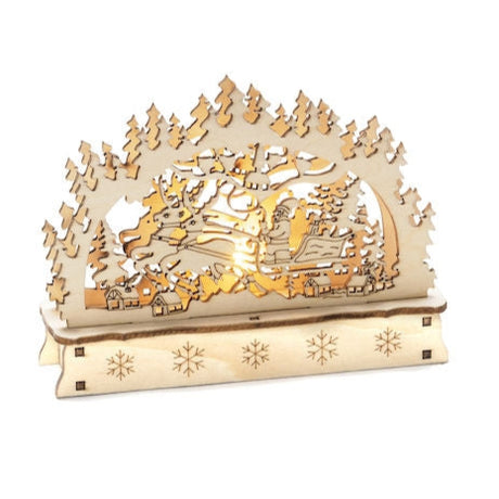 Wooden decorative piece with a detailed forest and deer scene, highlighted by star cutouts at the base and emitting a warm white glow, similar to the Candelabra: Konstsmide - Santa & Reindeer Sleigh with battery-operated LED lights.