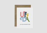 Card: Uffda Greeting Card 4.25"x5.5" features large multicolored "UFFDA" letters with "OH FOR GOODNESS SAKE" below, blank inside, and comes with a brown envelope—a playful Norwegian-Swedish expression for any occasion.