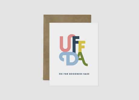 Card: Uffda Greeting Card 4.25"x5.5" features large multicolored "UFFDA" letters with "OH FOR GOODNESS SAKE" below, blank inside, and comes with a brown envelope—a playful Norwegian-Swedish expression for any occasion.