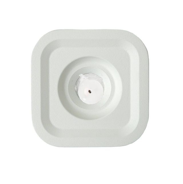 A square, white Stumpastaken Ettan candle holder (8.8x8.8x4 cm) in 100% recycled material, viewed from above, with clean lines and sustainable Scandinavian design echoing the simplicity of a central sensor pad.
