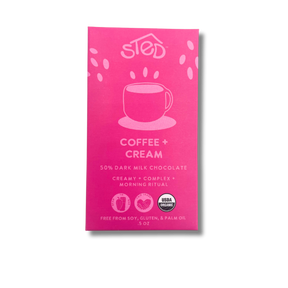 Bright pink chocolate bar wrapper with a coffee cup illustration and USDA Organic label, text indicating organic dark milk chocolate with Ethiopian coffee.