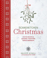 Cookbook cover with red Scandinavian-inspired patterns, mistletoe illustrations, and white text about Christmas recipes and traditions by Brontë Aurell.
