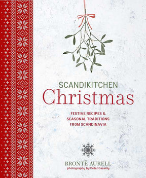 Cookbook cover with red Scandinavian-inspired patterns, mistletoe illustrations, and white text about Christmas recipes and traditions by Brontë Aurell.