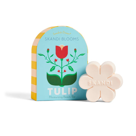 A flower-shaped, cruelty-free Skandi Blooms Tulip Bar Soap by Swedish Dream sits beside a blue box with a red tulip and the product name.