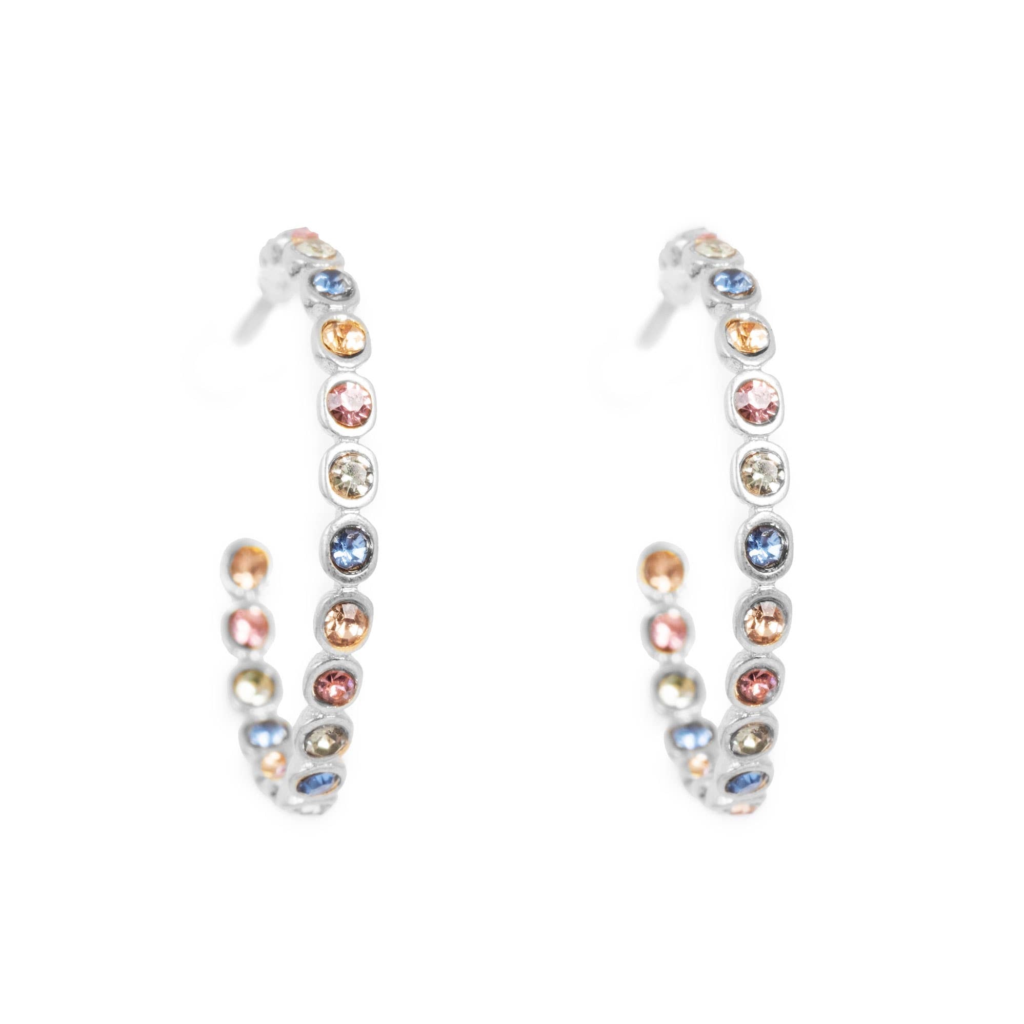 Introducing the Vibrance Silver Crystal Hoops Earrings: silver-plated brass hoops adorned with symmetrically arranged multicolored gemstones.