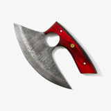 The Alaskan Ulu Style Knife features a curved Damascus steel blade with a red and black diamond wood handle, including a central finger hole.