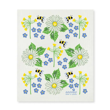 The Dish Cloth: Swedish Summer Flowers by Anneko Design Sweden features daisies, forget-me-nots, yellow blooms, and bees on white with “anneko made in Sweden” at the bottom—a lovely, eco-friendly, and practical addition to your kitchen.