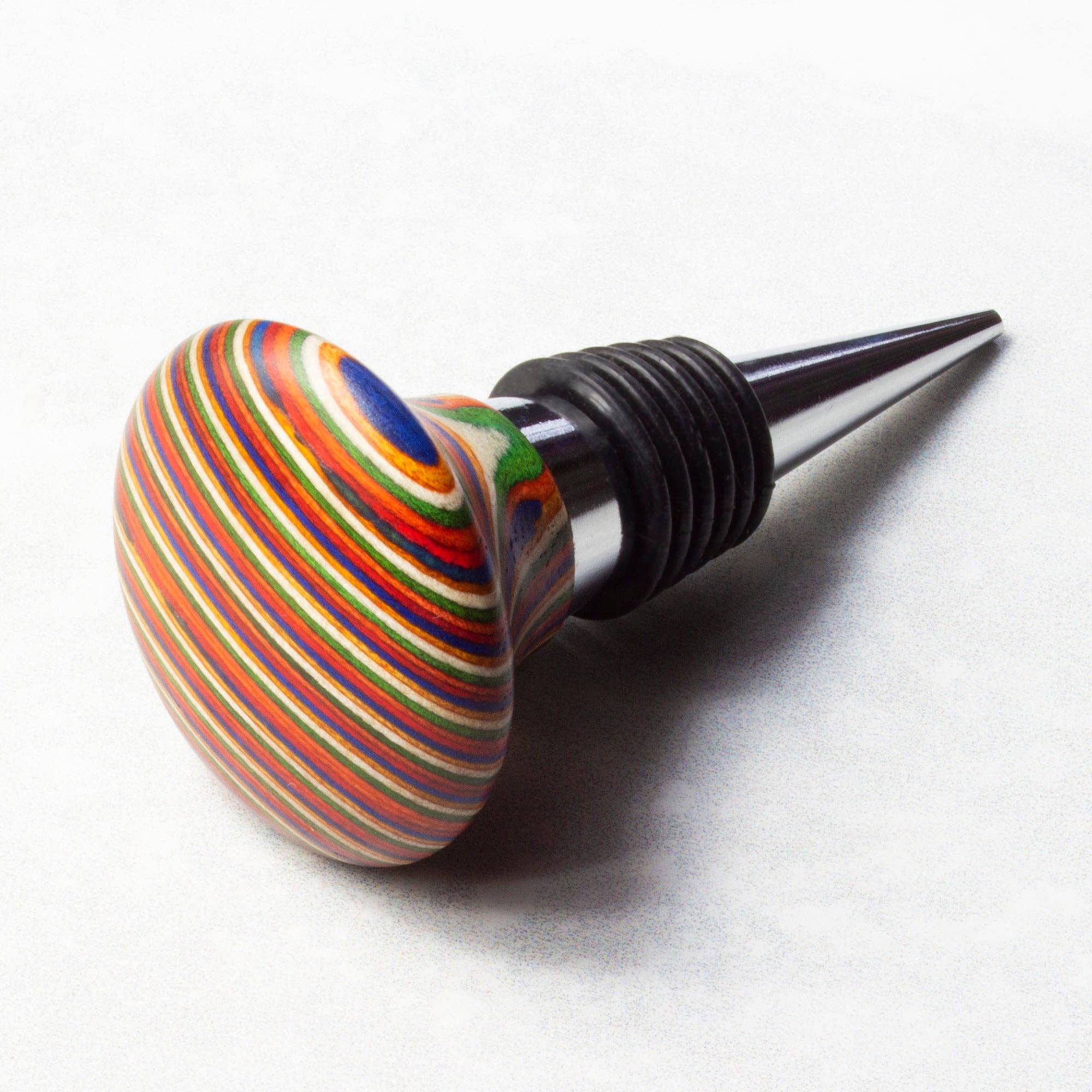 The Marrakesh Collection Wine Bottle Stopper showcases a colorful striped wooden design paired with a sleek metal cone and air-tight silicone rings to ensure a perfect seal.