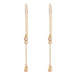 Earrings: A&C Oslo Long Crystal Chain Gold Earrings feature clear round gemstones and delicate gold chains with small dangling elements for a refined, organic look.