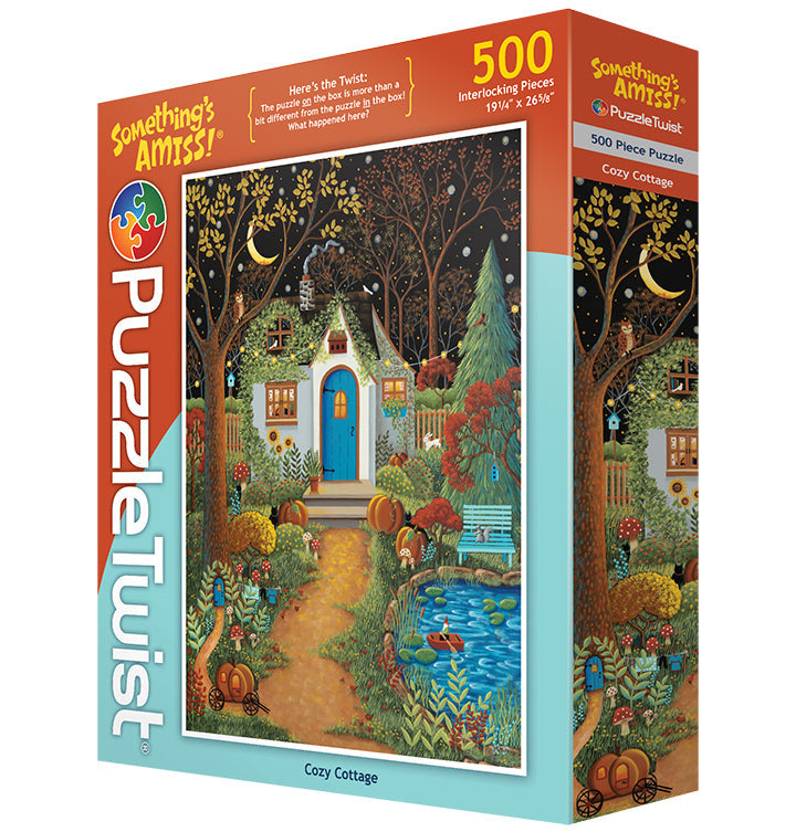 Box of PuzzleTwist Something's Amiss! Cozy Cottage 500 Piece puzzle by Mary Charles, featuring an illustrated autumn cottage scene with trees and a pond.