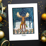 Artwork: Holiday Moose is an 11"x14" Giclee Print by Sarah Angst, featuring a moose in a colorful scarf amid a snowy, festive forest beneath a starry night sky.