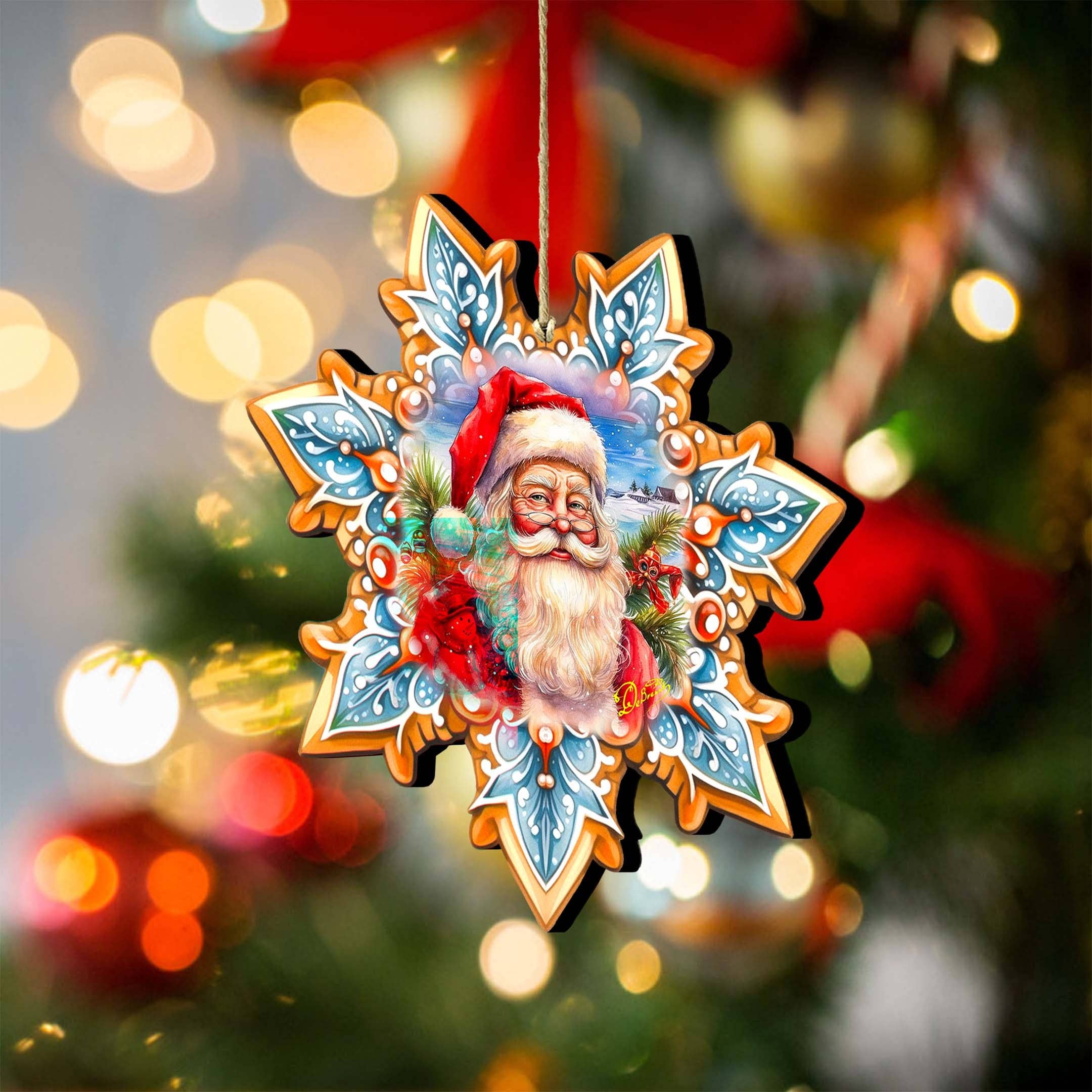 An Ornament: Santa Snowflake Wood Ornaments GDebrekht hangs on a decorated Christmas tree, showcasing a handcrafted wooden design with a Santa Claus illustration against the backdrop of blurred lights.