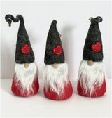 Three felt Tomte Scandinavian gnome figurines with gray hats, white beards, and red heart patches arranged in a row on a plain white background.