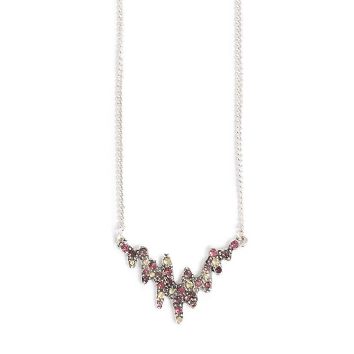 A silver chain necklace with a jagged, abstract pendant set with small red and yellow stones—quality design jewelry that perfectly complements the Northern Lights A&C Oslo Norway Pink & Gold Earrings.