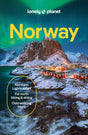 Cover of the Hachette Book Group’s “Lonely Planet Norway Northern Lights Safari Far North Hiking & Skiing Oslo Walking Tours Travel Guide” paperback, featuring snow-dusted mountains, vibrant houses, and the Northern Lights illuminating the sky. Text highlights unforgettable experiences such as Tromsø Northern Lights safaris, adventures in the Lofoten Islands, hiking and skiing excursions in the far north, and walking tours in Oslo.