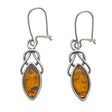 A pair of Celtic dangle earrings crafted from sterling silver, featuring genuine cognac Baltic amber stones in an intricate marquise-shaped design.