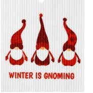 Above the text "Winter is Gnoming" on a Swedish Dish Cloth, three gnomes with red outfits, white beards, and tall hats are lined up.