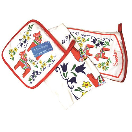 This delightful Swedish kitchen gift set, the Oven Mitts & Potholders: 3-Piece Dala Horse, comprises a pot holder, towel, and oven mitt. Each item is adorned with red borders and intricate floral patterns featuring iconic red Dala horses and the word "Sweden," making it a perfect mix of tradition and style for any cooking aficionado.