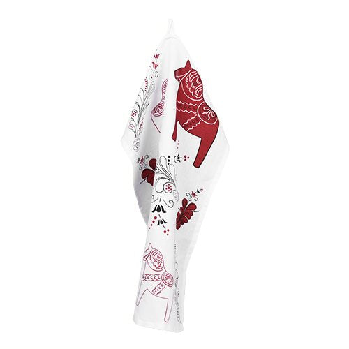 A tea towel called "Dala Horse & Kurbits Red & Black on White" is displayed on the wall, showcasing stylized Red Dala Horses along with red and black decorative prints.