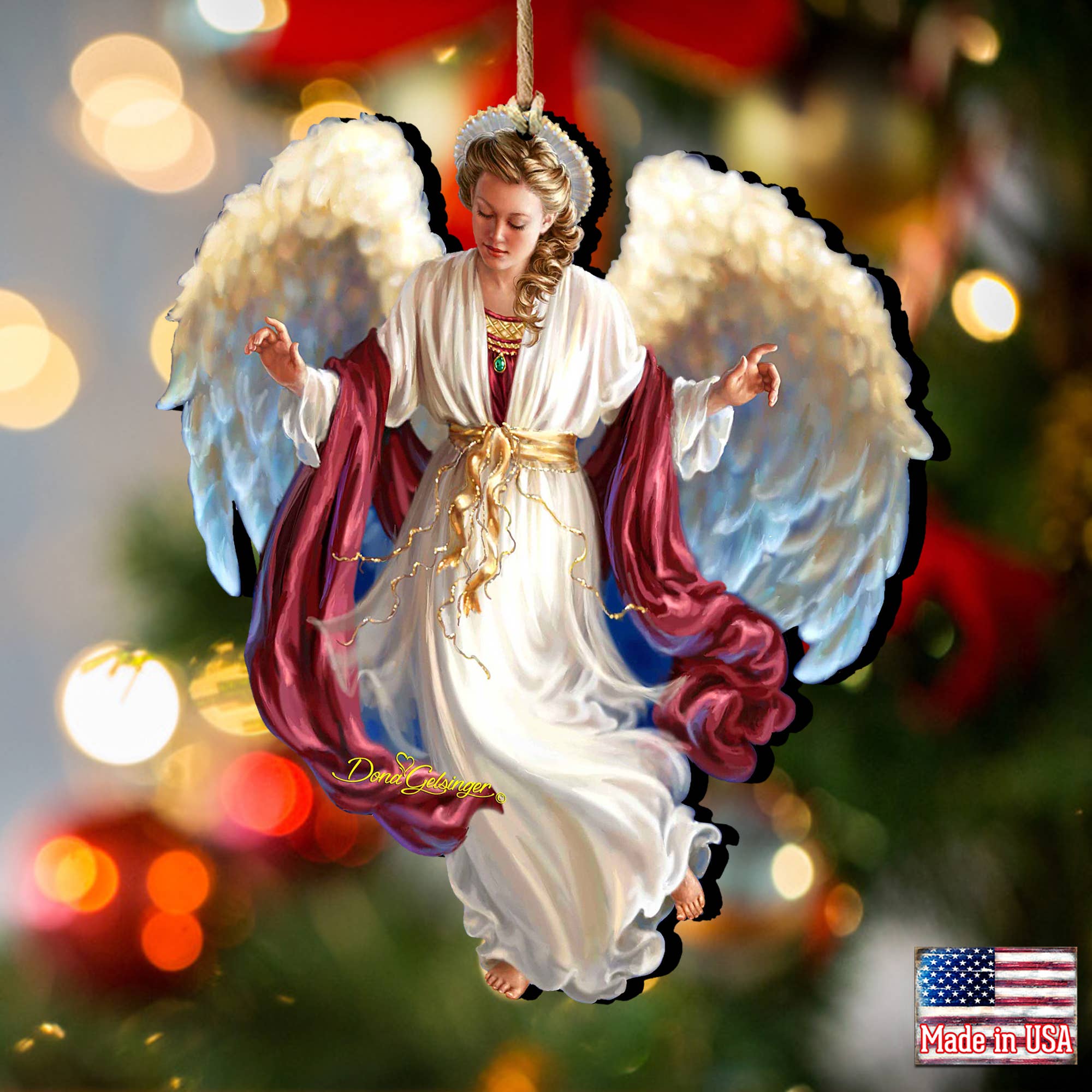 Peace on Earth Angel Wood Ornament by Dona Gelsinger showcases an angel with wings and a flowing robe, beautifully set against a blurred Christmas backdrop. Proudly handcrafted, this charming piece is adorned with a Made in USA label in the corner, making it a delightful addition to your holiday collection.