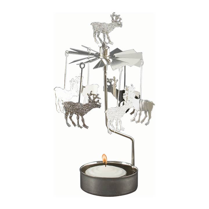 The Candle Holder: Reindeer Silver, crafted from recycled Swedish metal, includes a tealight at the base and features rotating reindeer figures elegantly suspended from a star-shaped top.