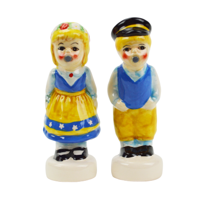 Two ceramic figurines resemble a magnetic kissing couple dressed in colorful traditional attire: the girl in a yellow dress and the boy in a blue vest with a cap. These Shakers: Swedish Couple Salt & Pepper Shakers make an enchanting Scandinavian gift.