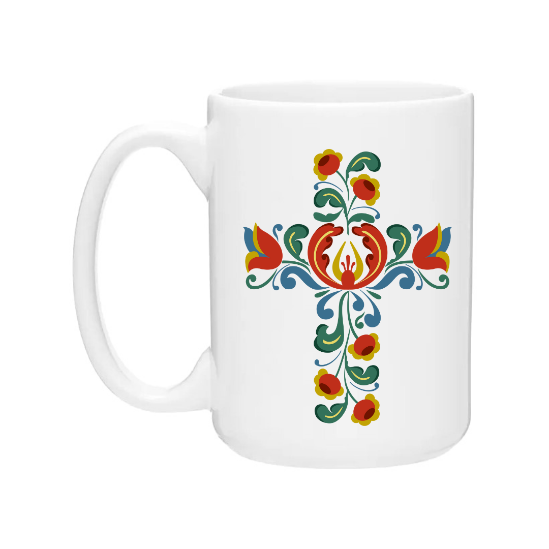 The Mugs: Norwegian Cross features a striking floral design in red, blue, green, and yellow patterns on a white ceramic coffee mug, crafted with the distinctive style of Cindy Lindgren Designs.