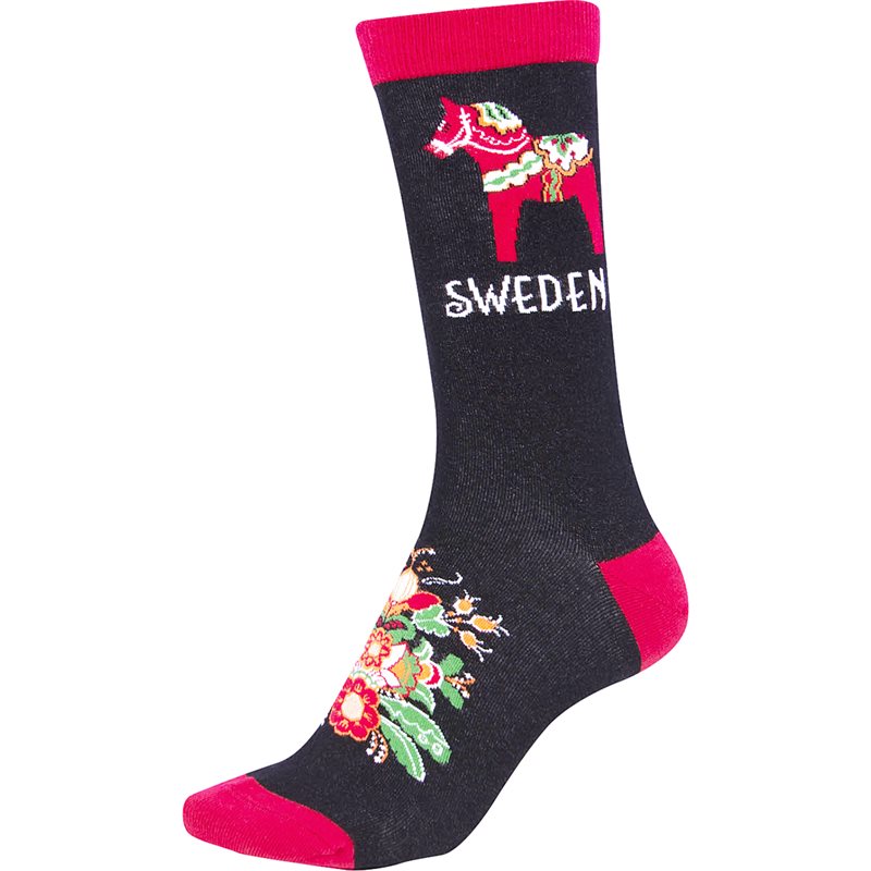 Black socks feature a red toe and heel, adorned with a red Dala Horse and SWEDEN at the top alongside colorful kurbits. Imported from Sweden.