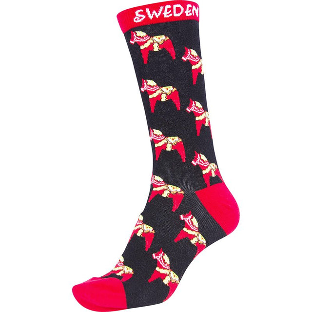 The Socks: Frost Scandinavian Youth Socks feature a black base with red heel and toe, highlighted by vibrant yellow and red Dala Horse designs. SWEDEN is elegantly printed in white at the top, making them ideal Scandinavian childrens socks.